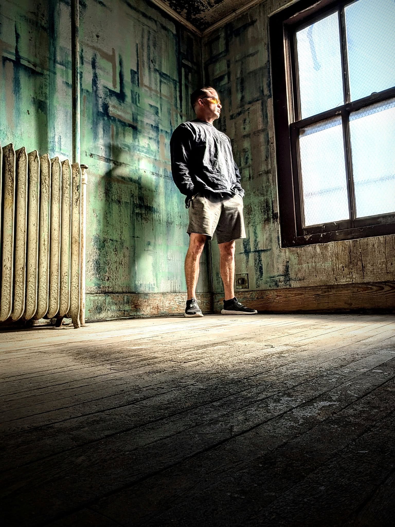 Jon Thomas Buck standing beside a tall window